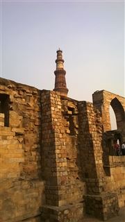 Qutab Still Standing Within The Ruins 