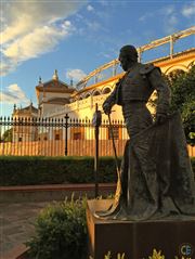 Bullring And Silhouetted Bull Fighter Statue